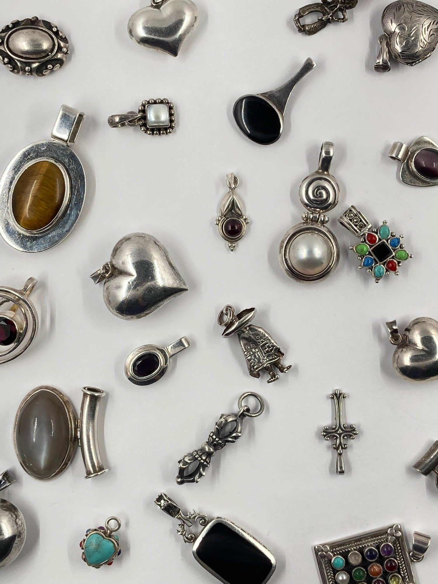 a collection of vintage and antique silver pendant's